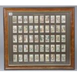 A display of John Player “Cries of London” cigarette cards. (50 of 50), in a glazed frame.