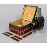 An early 20th century German magic lantern in a painted deal box; & thirteen various coloured