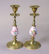 A pair of continental pink-ground porcelain & brass candlesticks on round bases, 8¼” high.