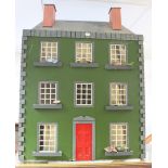 A modern painted wooden two-storey doll’s house with an opening front, 25” wide x 33” high x 12½”