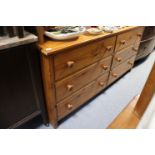 A pine long dwarf chest fitted two ranks of three long drawers with turned knob handles, 56¾” long x