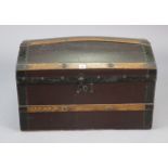 An early 20th century small leatherette-covered oak domed-top travelling trunk with a hinged lift-