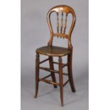 A late 19th/early 20th century child’s spindle-back correction chair with a hard seat, & on round
