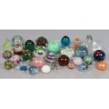 A collection of thirty two various glass paperweights including examples by Caithness, Wedgwood, etc