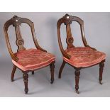 A pair of 19th century Athenian-style carved mahogany dining chairs each with a buttoned seat & on