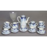 A blue & white porcelain floral decorated twenty-one piece coffee service; & a glass drinking vessel
