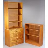 A teak tall side cabinet having three open shelves above an open recess & fitted four long drawers