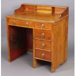 A pine knee-hole small desk fitted with an arrangement of five drawers, 29½” wide x 31½” high.