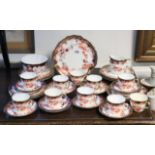 A Royal Crown Derby Imari part tea service comprising: one slop bowl, one milk jug, eleven