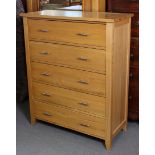 A light oak chest fitted five long drawers with silvered-metal handles, 37¾” wide x 46¼” high x 16¾”