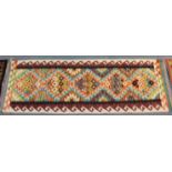 A Chobi kilim runner with repeating geometric designs in red & cream hook borders, 188cm x 61cm.