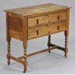 A 1930’s oak chest fitted two long drawers, & on barley-twist legs & turned feet with plain