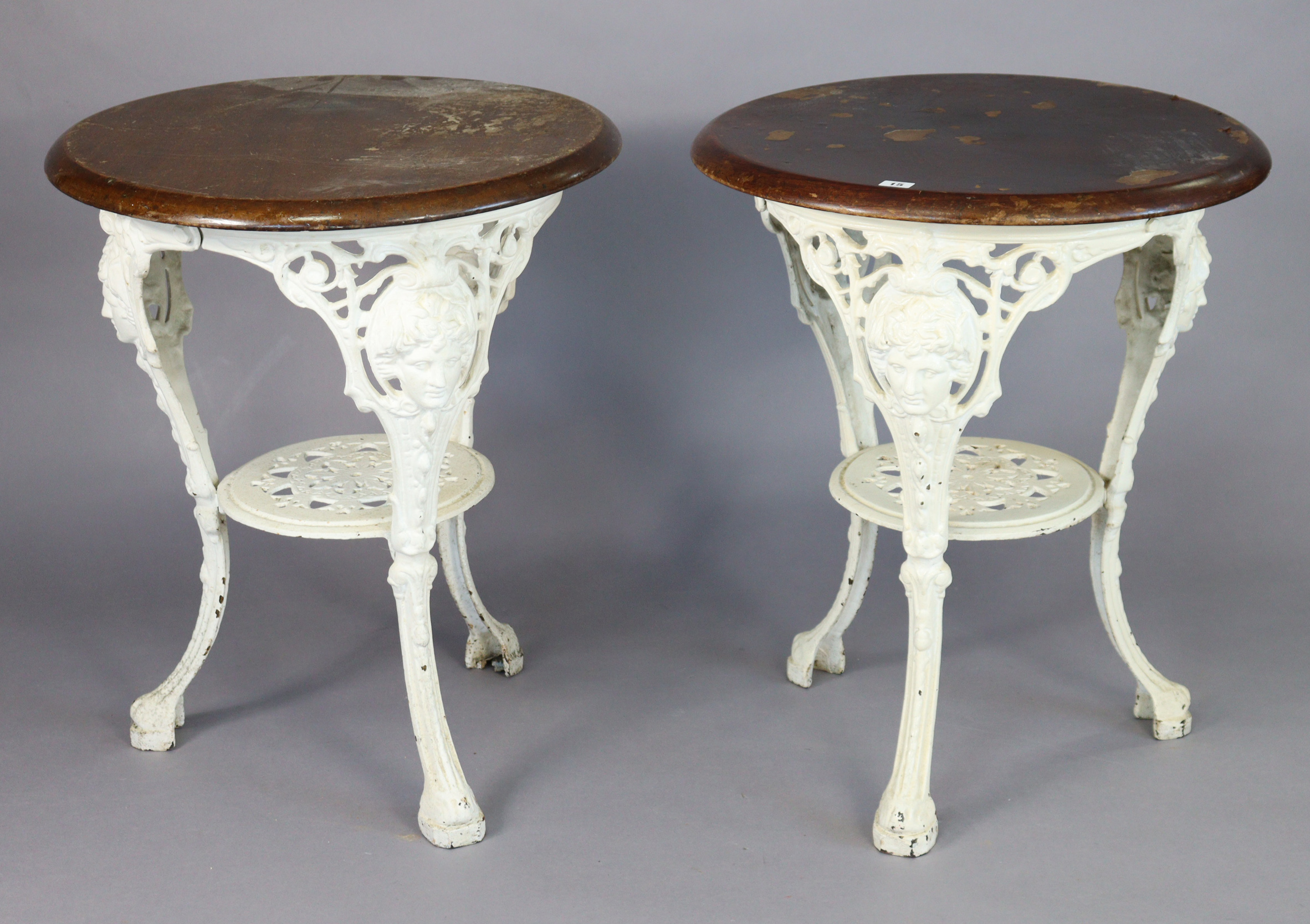 Two white painted cast-iron “Britannia” pub tables, each with a wooden top, 23½” diameter x 28”