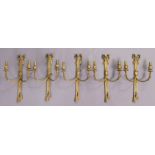 A set of five late 20th century gilt-brass twin-branch wall scones of ribbon-bow design, each 23cm