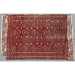An antique Persian rug with all-over design of flower-heads & blue star motifs within narrow