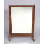 A 19th century mahogany swing dressing mirror with inlaid chequered border, on shaped supports