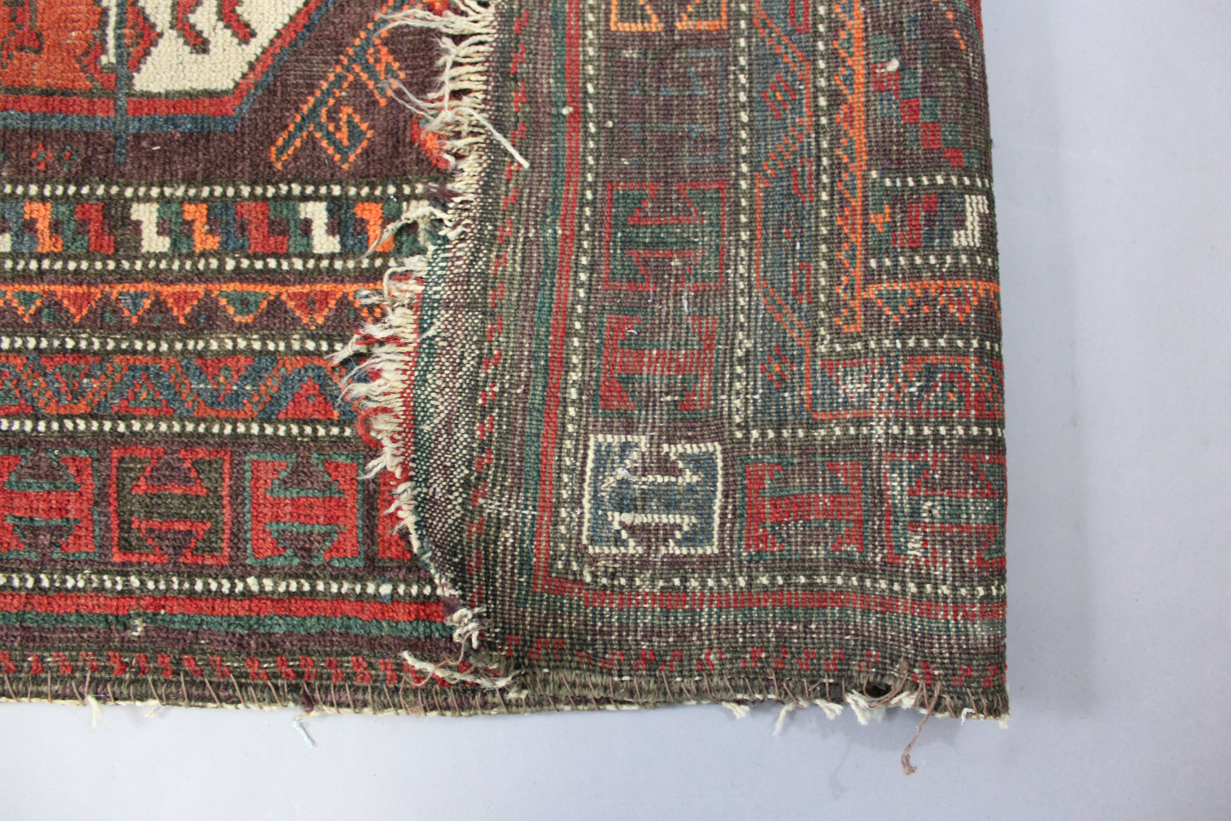 An antique Caucasian rug of multicoloured geometric design with two rows of seven octagonal panels - Image 2 of 3