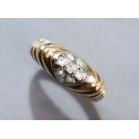 A yellow 14K ring, the gadrooned head set cluster of small white stones; size: O; 3.4. gm.