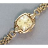 An Avia 9ct. gold bracelet watch, the silvered cushion-shaped dial with alternating gilt Arabic &