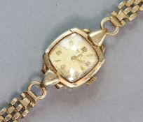 An Avia 9ct. gold bracelet watch, the silvered cushion-shaped dial with alternating gilt Arabic &