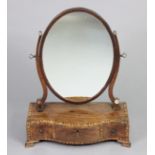 A 19th century inlaid mahogany swing toilet glass, the oval mirror on scroll supports, fitted