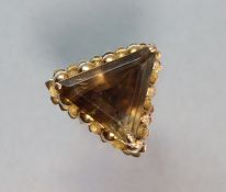 A yellow 14K ring set large triangular-cut smokey quartz; size: P 12.2 gm.