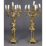 A pair of modern very large cast-metal table candelabra on figural supports, each with six foliate