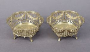 A pair of Edwardian silver lobed circular sweetmeat dishes with flower swags to the pierced sides,