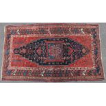 An antique Caucasian large rug with all-over multicoloured geometric design, large dark blue