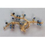 A 14K yellow brooch naturalistically modelled as tree branches set eighteen small sapphire; 6.4 cm