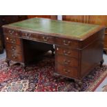 A Victorian-style mahogany pedestal desk inset gilt-tooled green leather writing surface to the