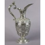 AN EARLY VICTORIAN SILVER ‘CELLINI’ WINE EWER with all-over repousse decoration of masks, animals,