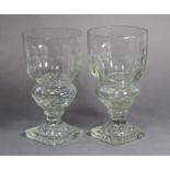 A pair of early 19th century style cut glass drinking glasses with fluted bodies on faceted hollow