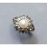 A 14K white flower-head ring centred by a cultured pearl within a border of small diamonds; size: S;