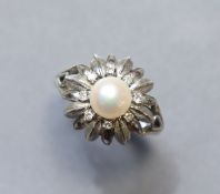 A 14K white flower-head ring centred by a cultured pearl within a border of small diamonds; size: S;