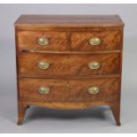 A Georgian mahogany bow-front chest fitted two short & two long graduated drawers with oval brass