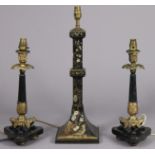 A pair of late 20th century regency-style cast metal candlestick-form table lamps on black marble