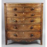 A Victorian inlaid mahogany bow-front chest fitted two short & four long drawers with turned knob