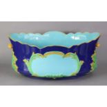 A MINTON MAJOLICA OVAL JARDINIERE, of deep blue ground with turquoise interior & cartouche to each