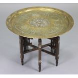 A middle eastern brass circular table with silvered & copper inlay, on mother-of-pearl inlaid