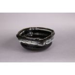 A Japanese studio pottery Mingei style Seto ware bowl in tenmoku glaze with white ash to the