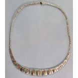 A 9ct. three-coloured gold fringe necklace, 41.5 cm long. (7.2 gm).