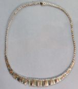 A 9ct. three-coloured gold fringe necklace, 41.5 cm long. (7.2 gm).