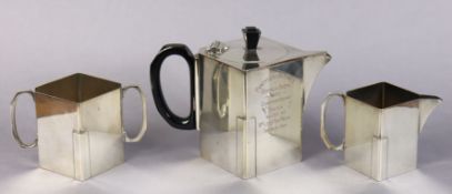 An Art Deco silver-plated three piece tea service of straight-sided lozenge shape, with engraved dec