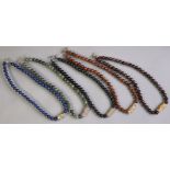 Five hardstone bead necklaces including garnet, black onyx, serpentine, & obisidian, each with a foc