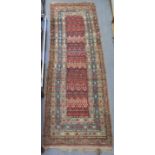 An antique Qashqai runner, the central field with repeating floral motifs in multiple borders;