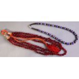 A necklace of antique six-layer overlaid glass beads with contemporary garnet spacers; & a multi-str