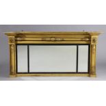 An early 19th century giltwood triple-panel overmantel mirror with turned pilasters & ebonised