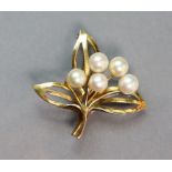 A 14K yellow open-work leaf brooch set five cultured pearls; 3.5 wide. (5.1 gm).