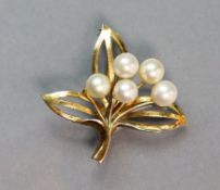 A 14K yellow open-work leaf brooch set five cultured pearls; 3.5 wide. (5.1 gm).